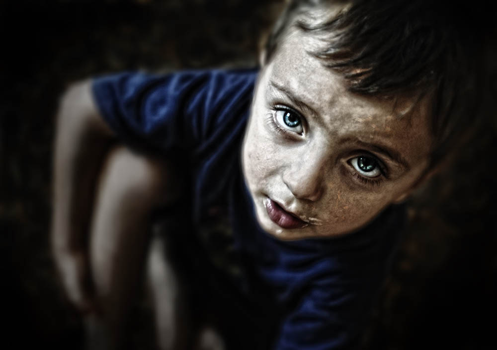 sad-looking-child-portrait-on-black-background-P8UD6EC.jpg